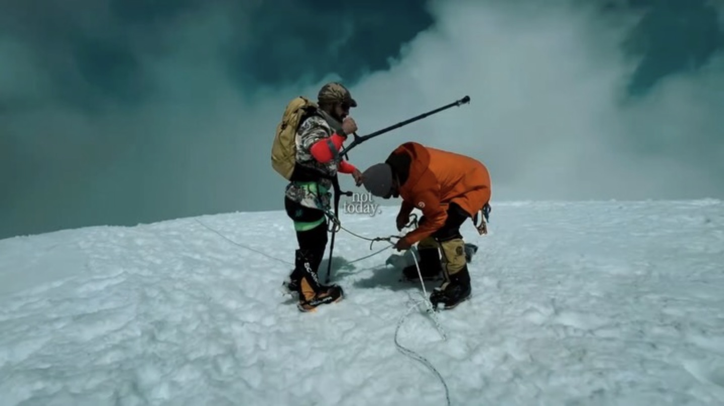 David and an expedition teammate on a snowy slope